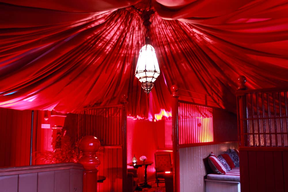Image of a red canopied ceiling in a stable