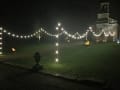 Winter Wedding Afternoon shot of Fire-pits alongside Festoon lighting entrance way.