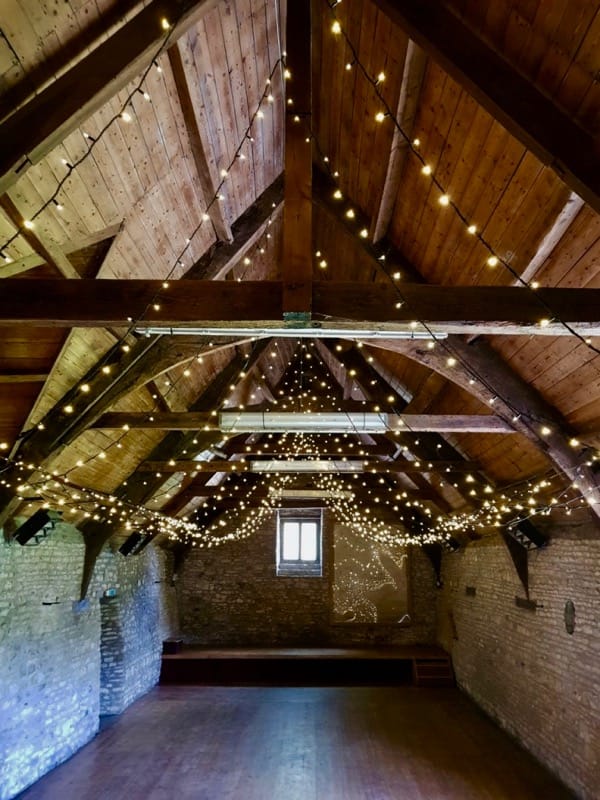 Mells Barn with fairy-lights installed in the ceiling.